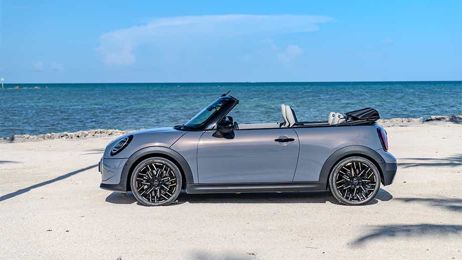 Side profile of a Mini Cooper S Convertible on a beach