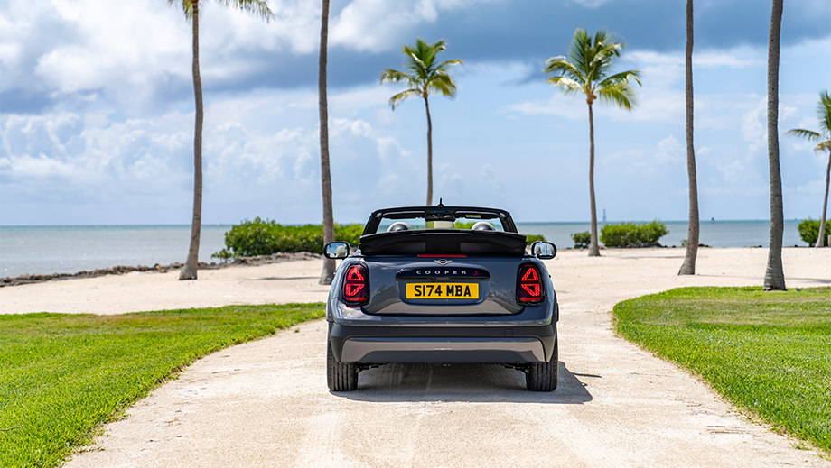 Rear view of a Mini Cooper S Convertible on a beach road