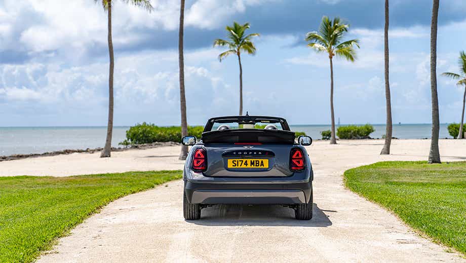 Rear view of a Mini Cooper S Convertible on a beach road