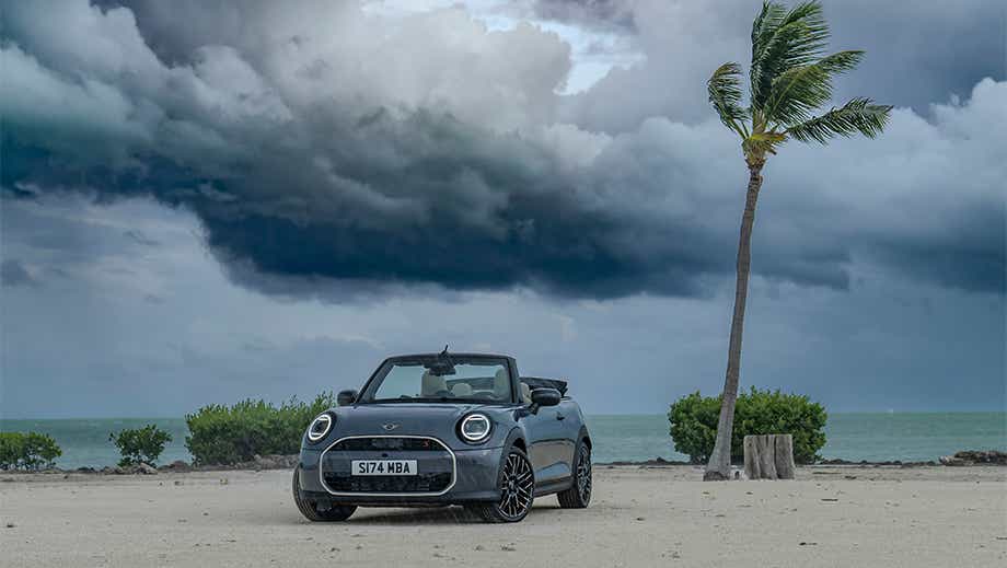 Front view of a Mini Cooper S Convertible on a beach