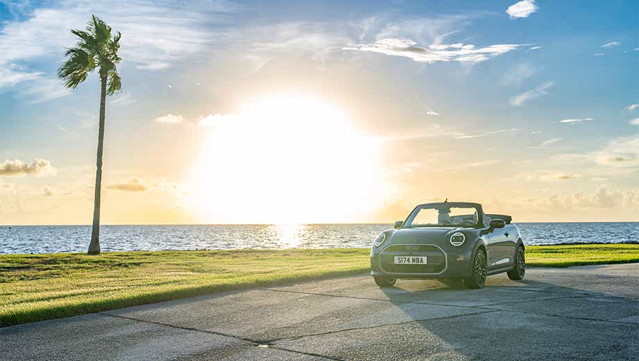 Front three quarter of a Mini Cooper S Convertible by the seaside road