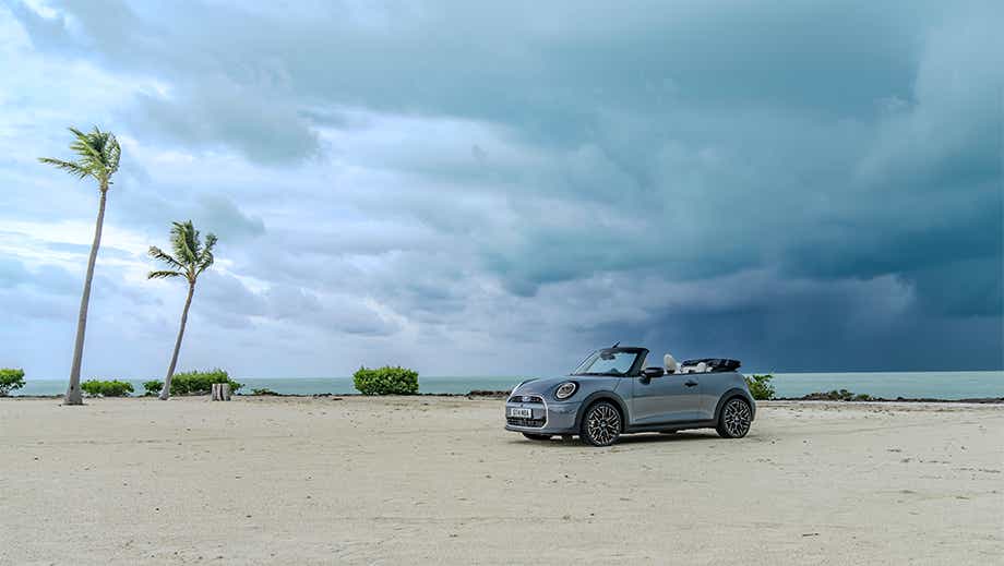 Front three quarter view of a Mini Cooper S Convertible on a beach