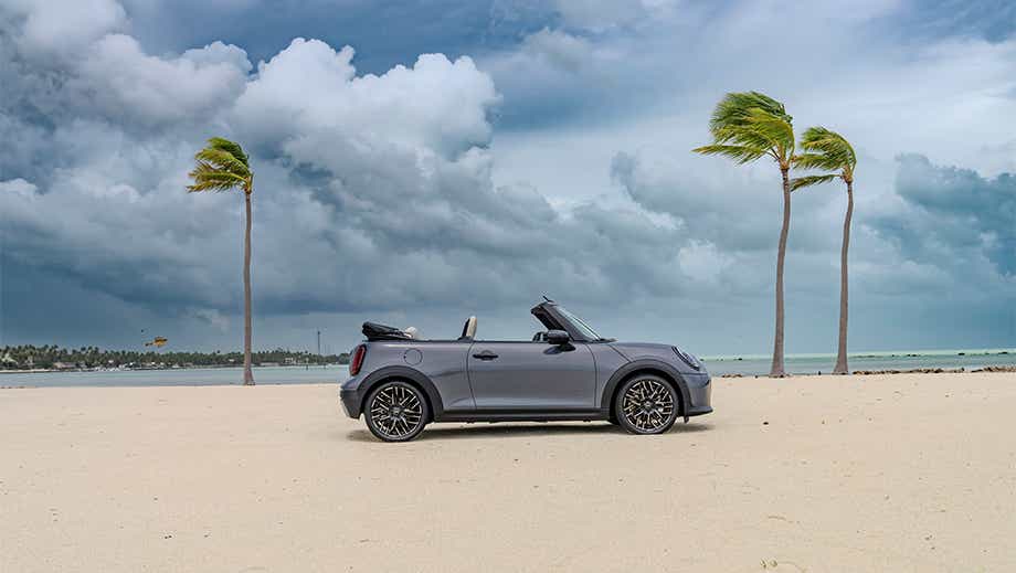 Side view of a Mini Cooper S Convertible on a beach
