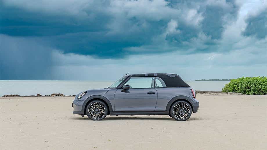 Side view of a Mini Cooper S Convertible on a beach