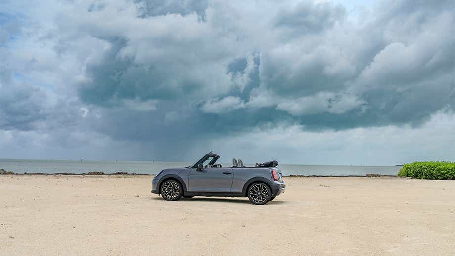 Side view of a Mini Cooper S Convertible on a beach
