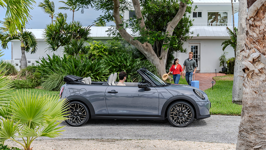 Side view of a Mini Cooper S Convertible parked outside a house