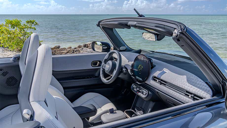 Interior front seats and dashboard of a Mini Cooper S Convertible by the ocean