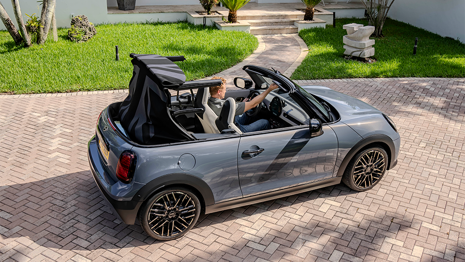 Rear three quarter view of a Mini Cooper S Convertible with convertible roof open