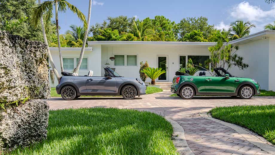 Side view of a british racing green mini cooper s convertible