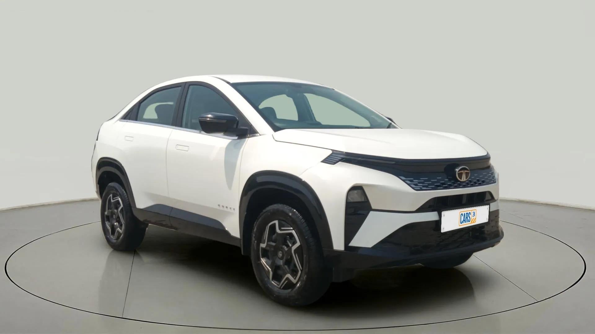 Front three-quarter view of a Pristine White Tata Curvv