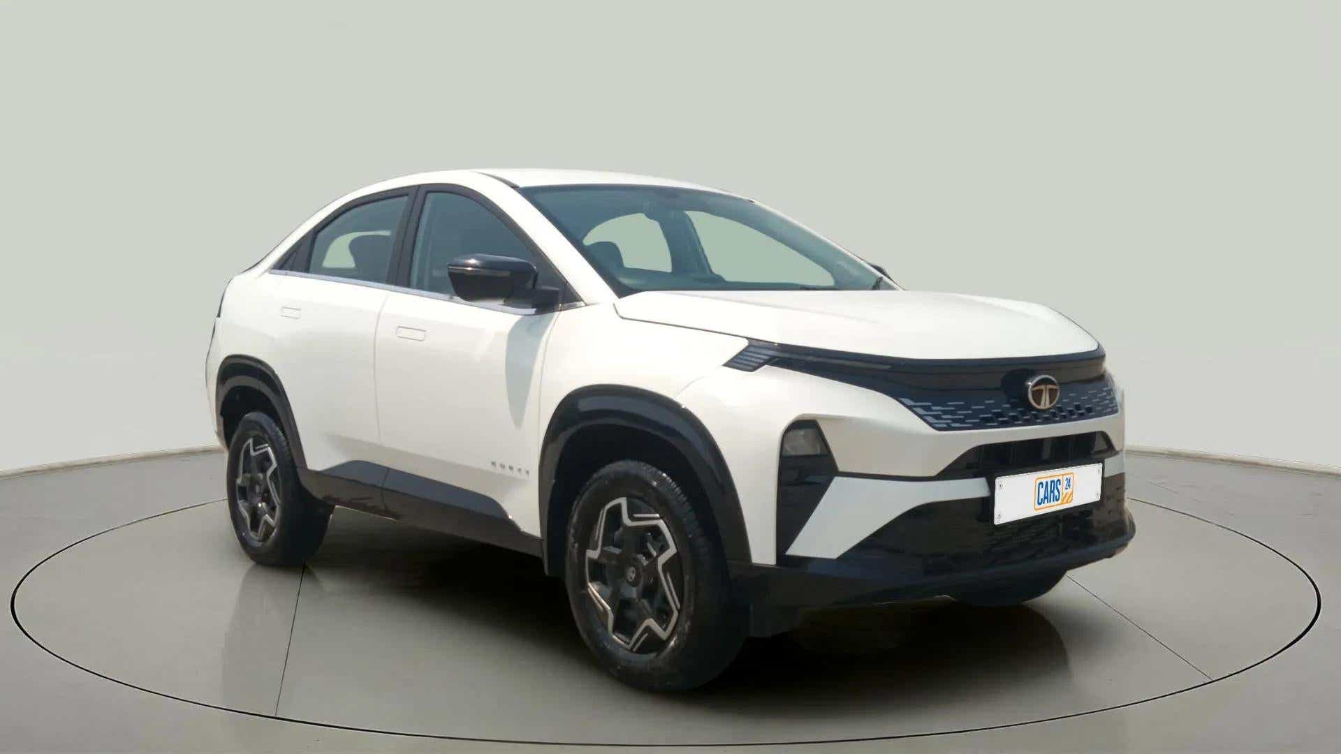 Front three-quarter view of a Pristine White Tata Curvv