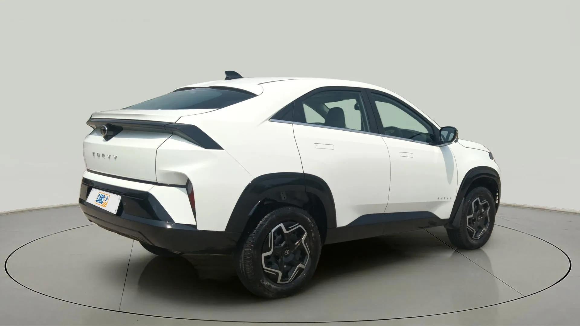 Rear three-quarter view of a Pristine White Tata Curvv