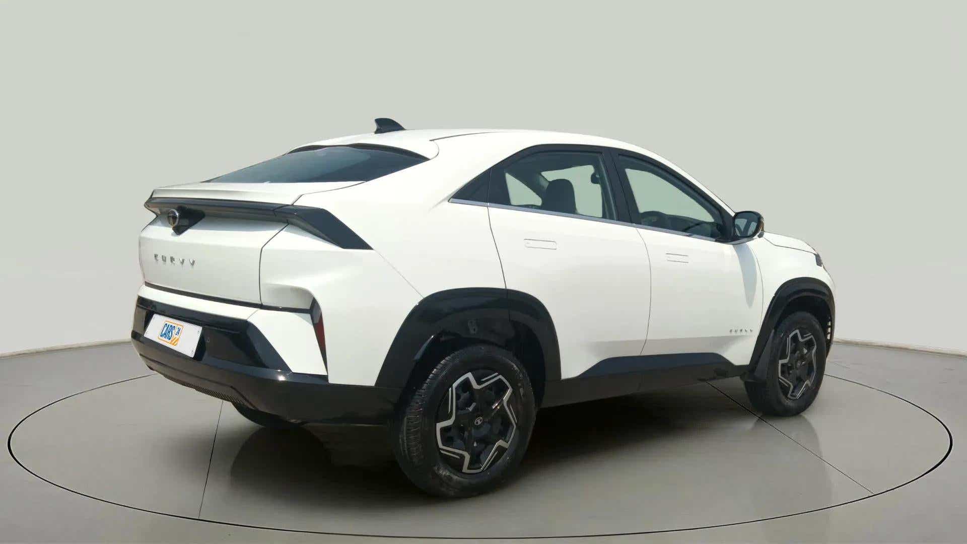 Rear three-quarter view of a Pristine White Tata Curvv