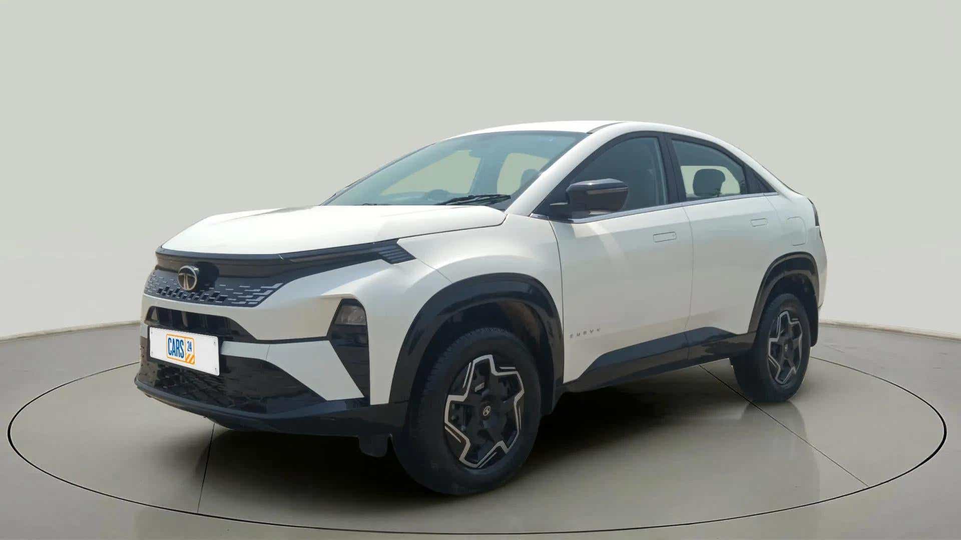 Front three-quarter view of a Pristine White Tata Curvv