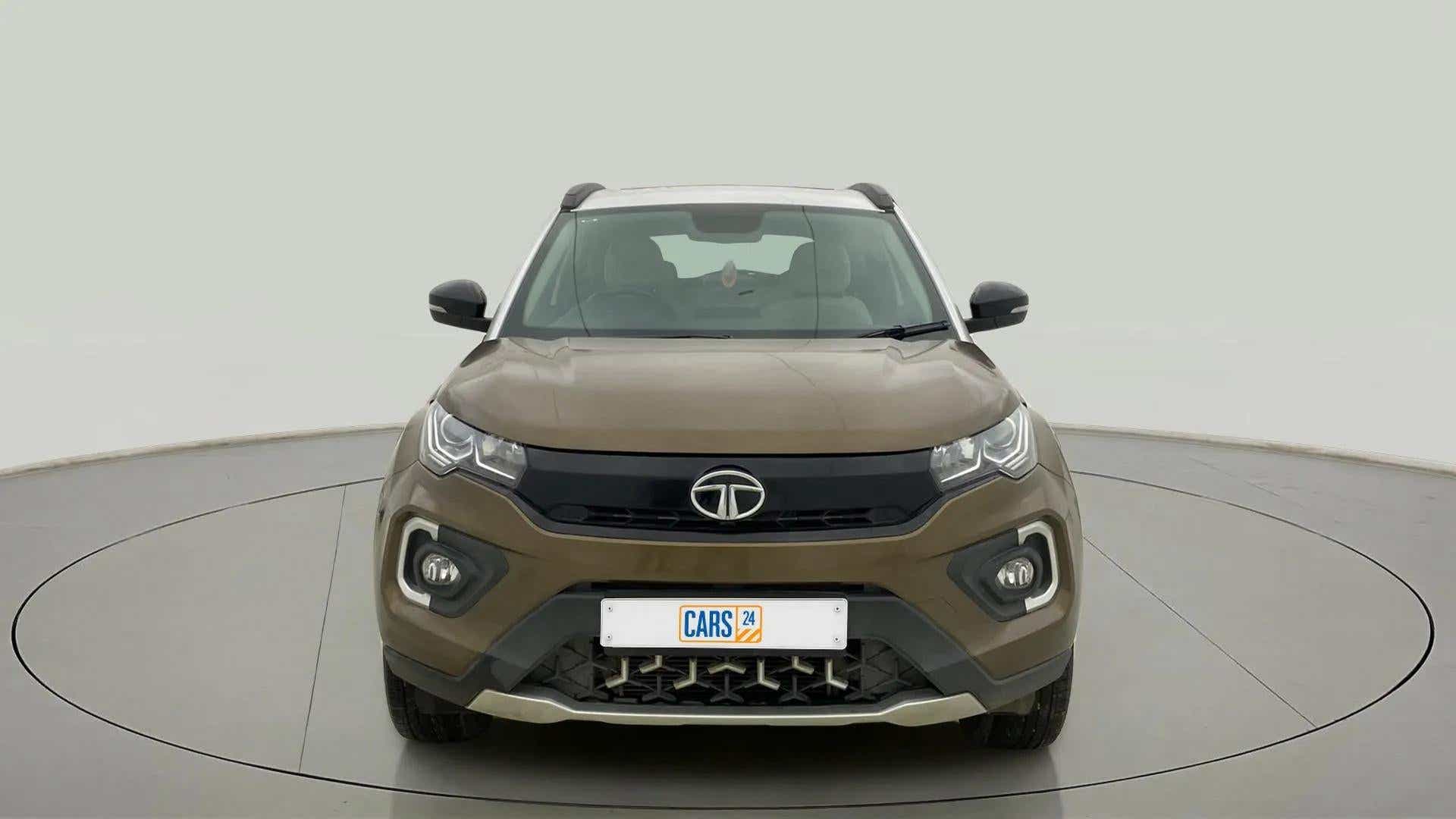 Front view of a Grassland Beige Tata Nexon 2017-2023