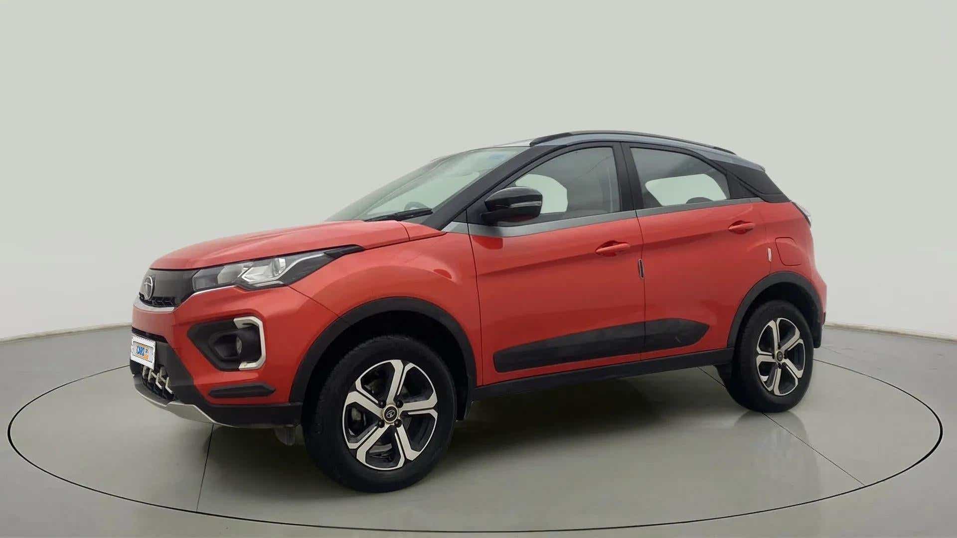 Front side view of a flame red Tata Nexon 2017-2023