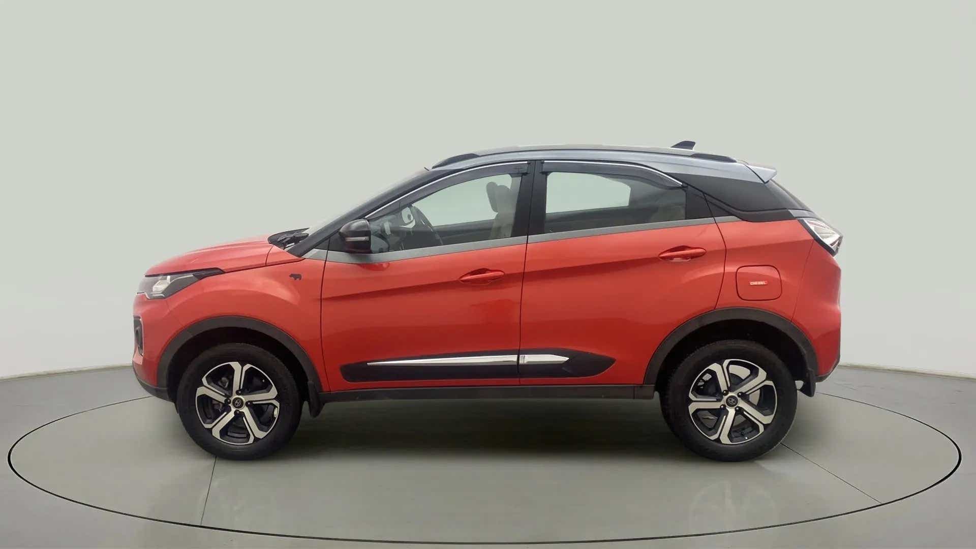 Side view of a flame red Tata Nexon 2017-2023
