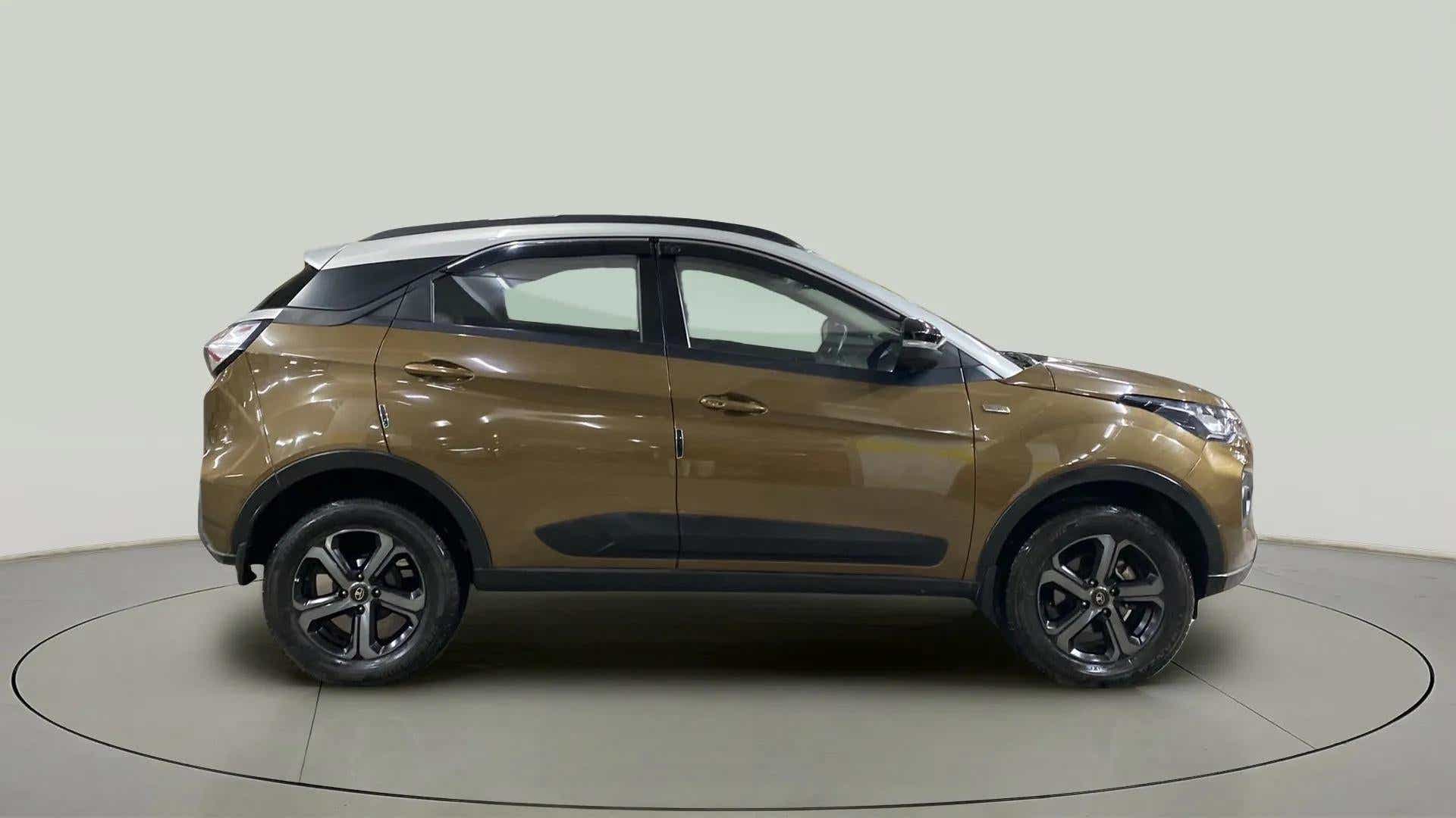 Side view of a Grassland Beige Tata Nexon 2017-2023