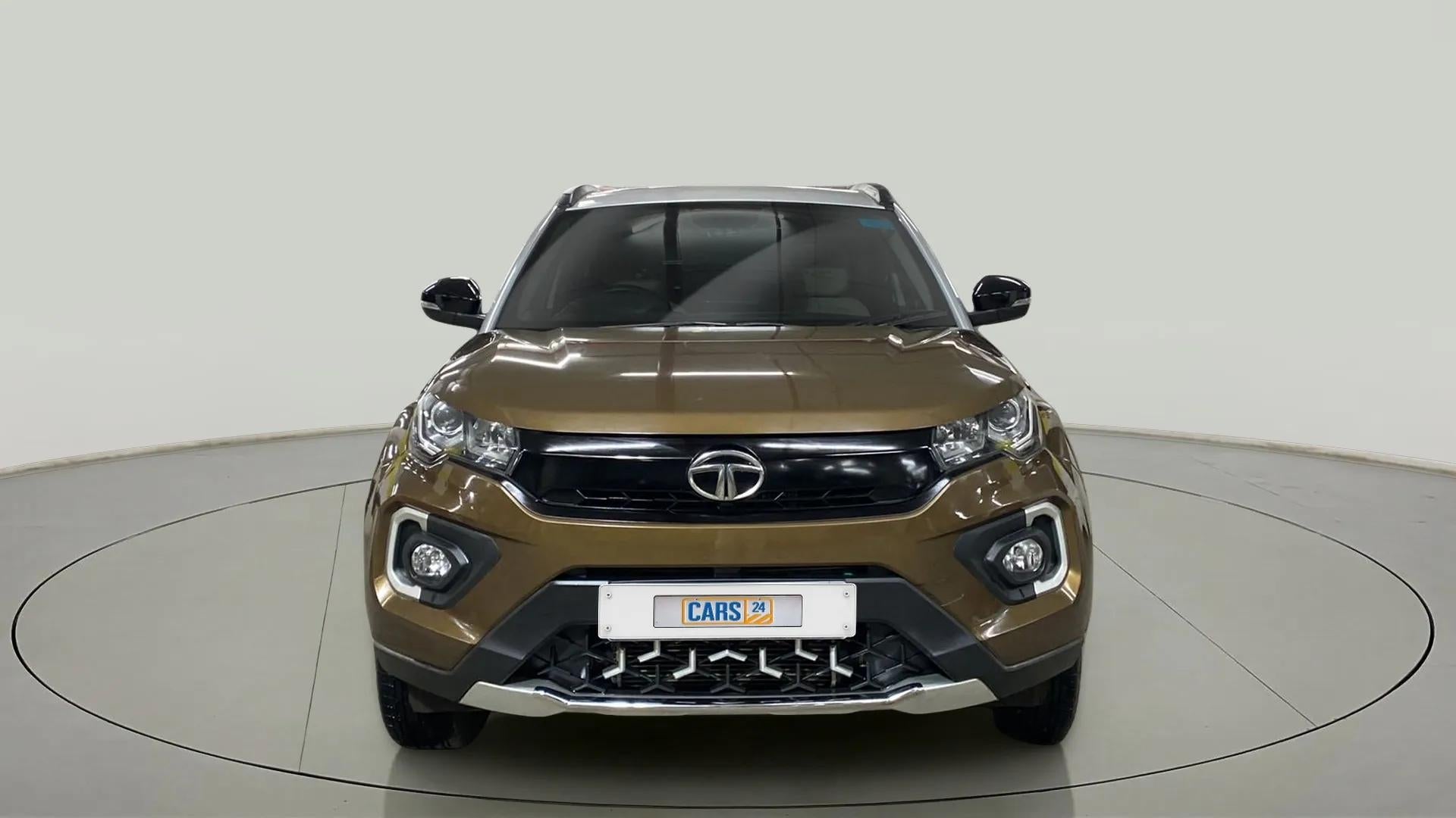 Front view of a Grassland Beige Tata Nexon 2017-2023