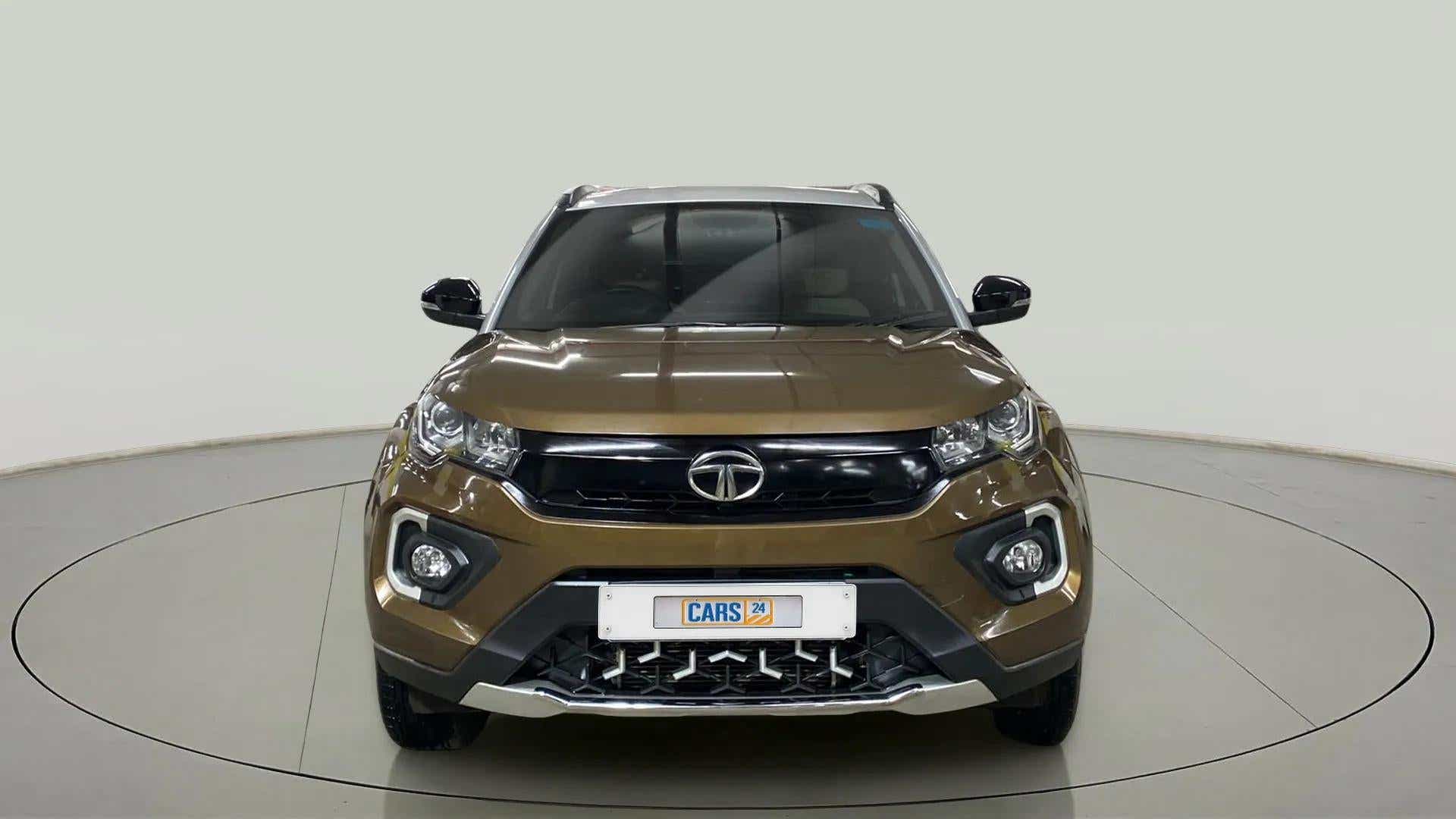 Front view of a Grassland Beige Tata Nexon 2017-2023