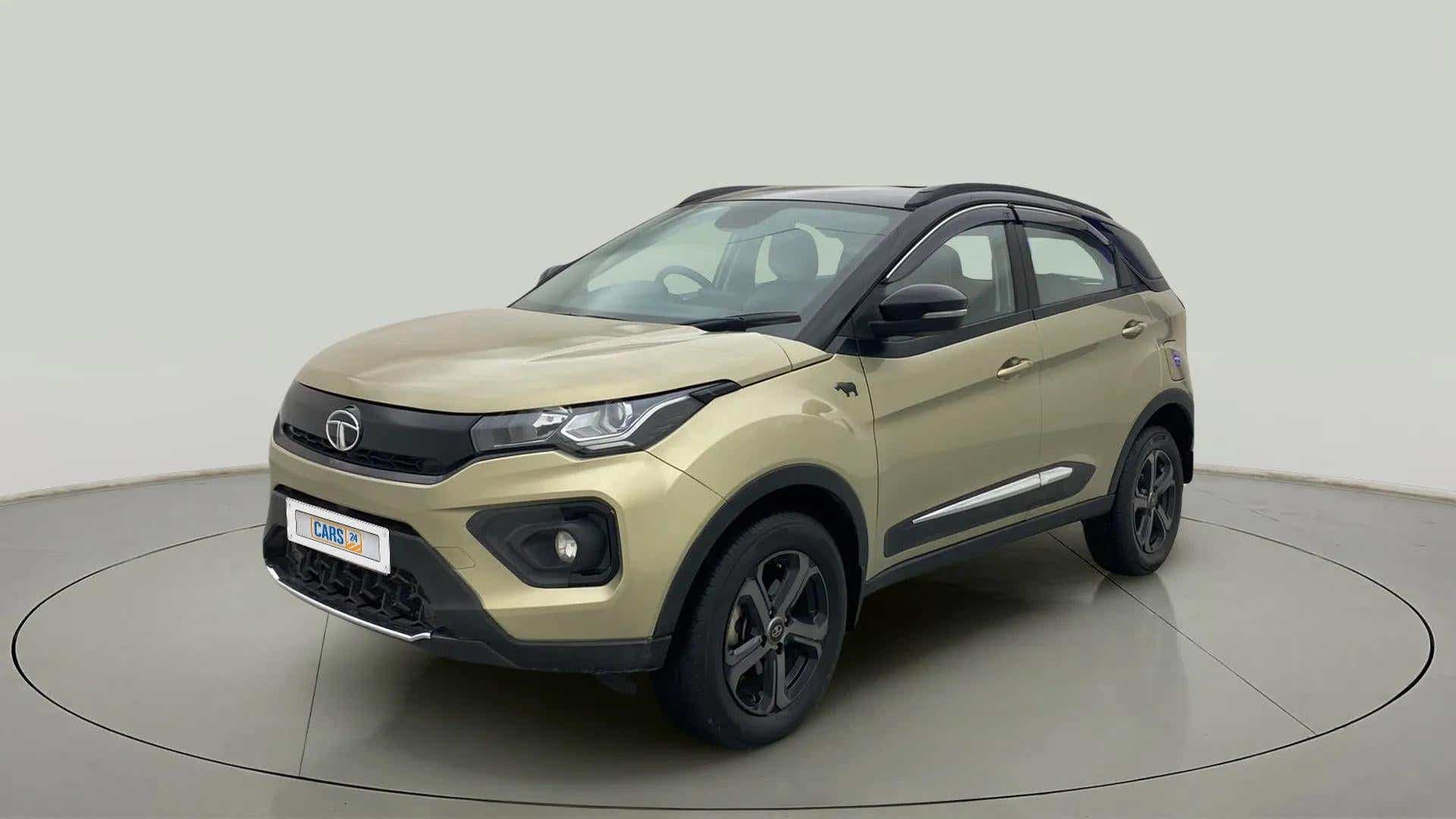 Front three-quarter of a Grassland Beige Tata Nexon 2017-2023