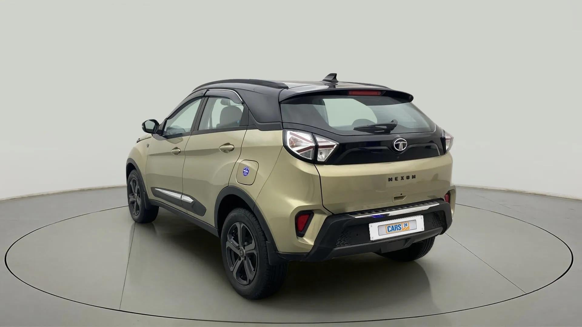 Rear three-quarter of a Grassland Beige Tata Nexon 2017-2023