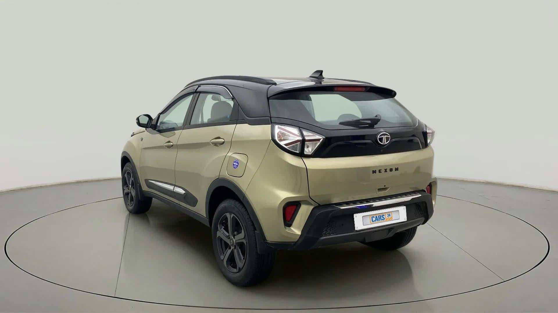 Rear three-quarter of a Grassland Beige Tata Nexon 2017-2023