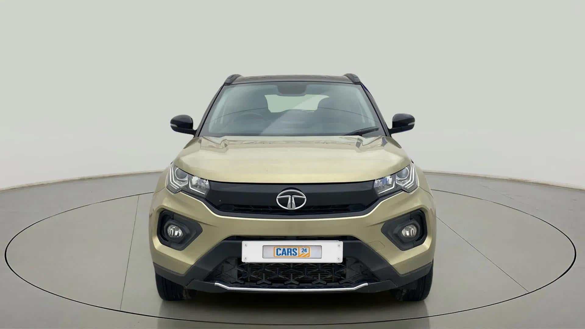 Front view of a Grassland Beige Tata Nexon 2017-2023