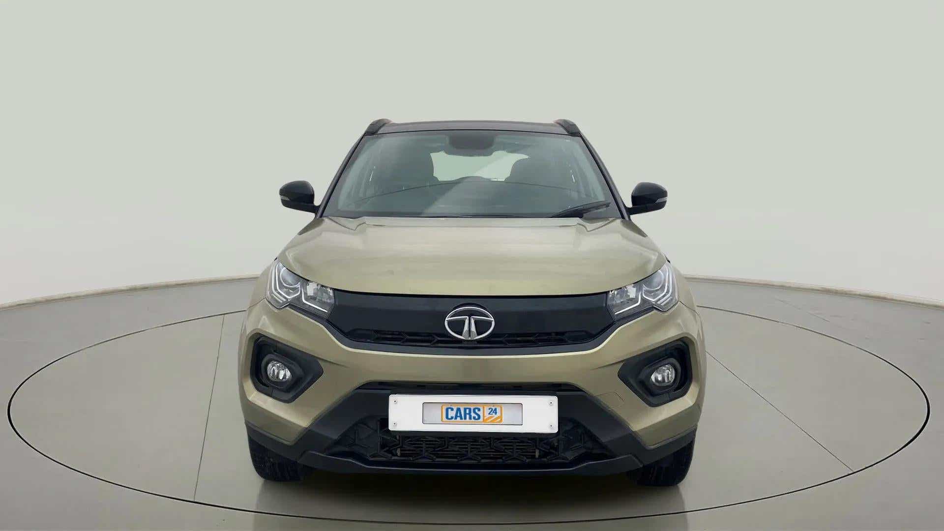 Front view of a Grassland Beige Tata Nexon 2017-2023