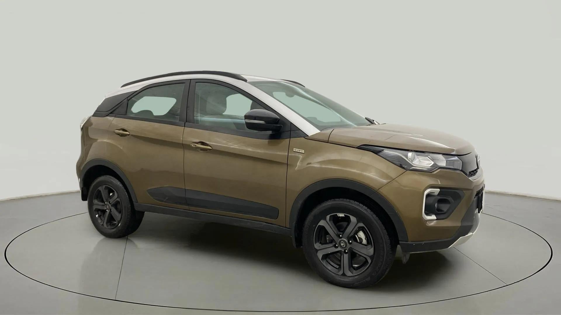 Front side view of a Grassland Beige Tata Nexon 2017-2023
