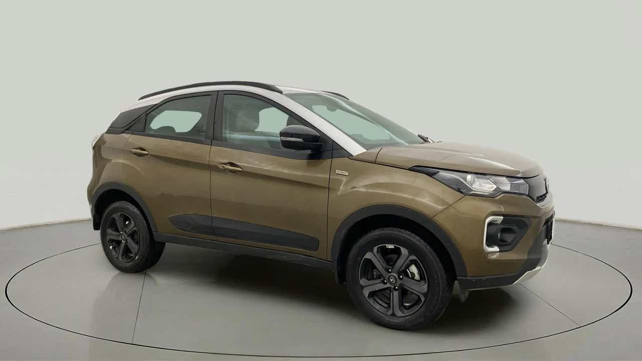 Front side view of a Grassland Beige Tata Nexon 2017-2023