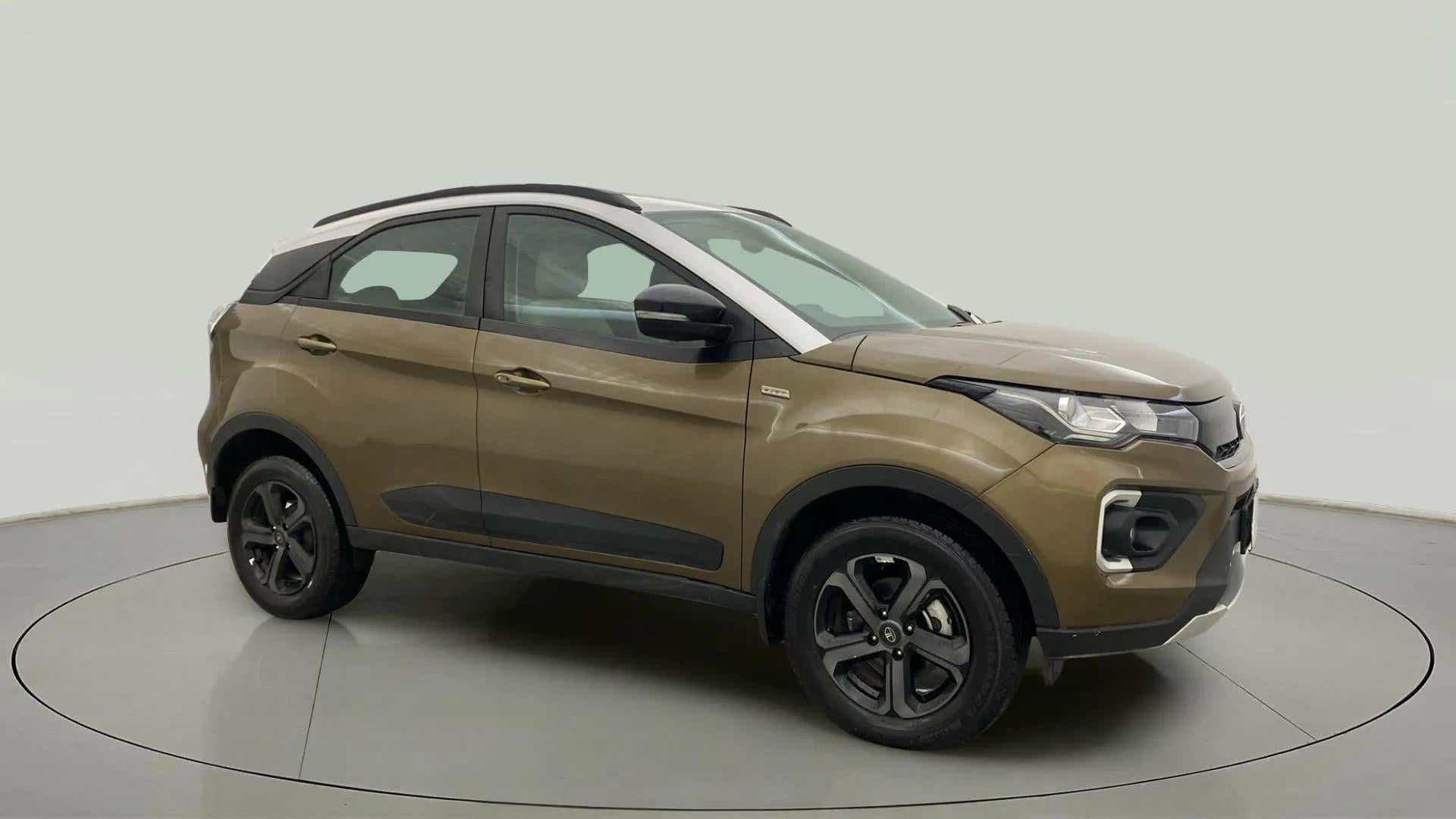 Front side view of a Grassland Beige Tata Nexon 2017-2023