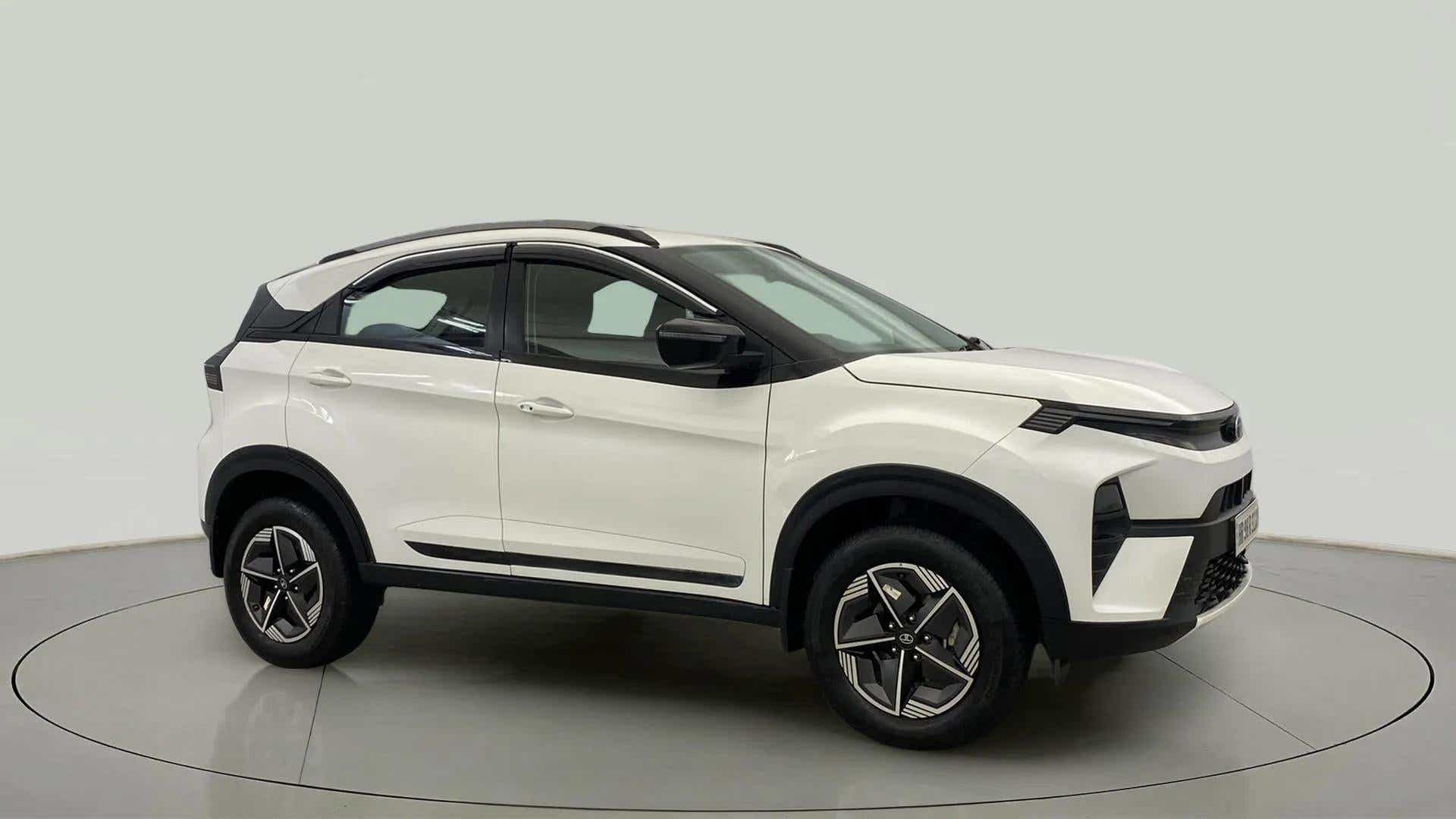 Side view of a Calgary White Tata Nexon