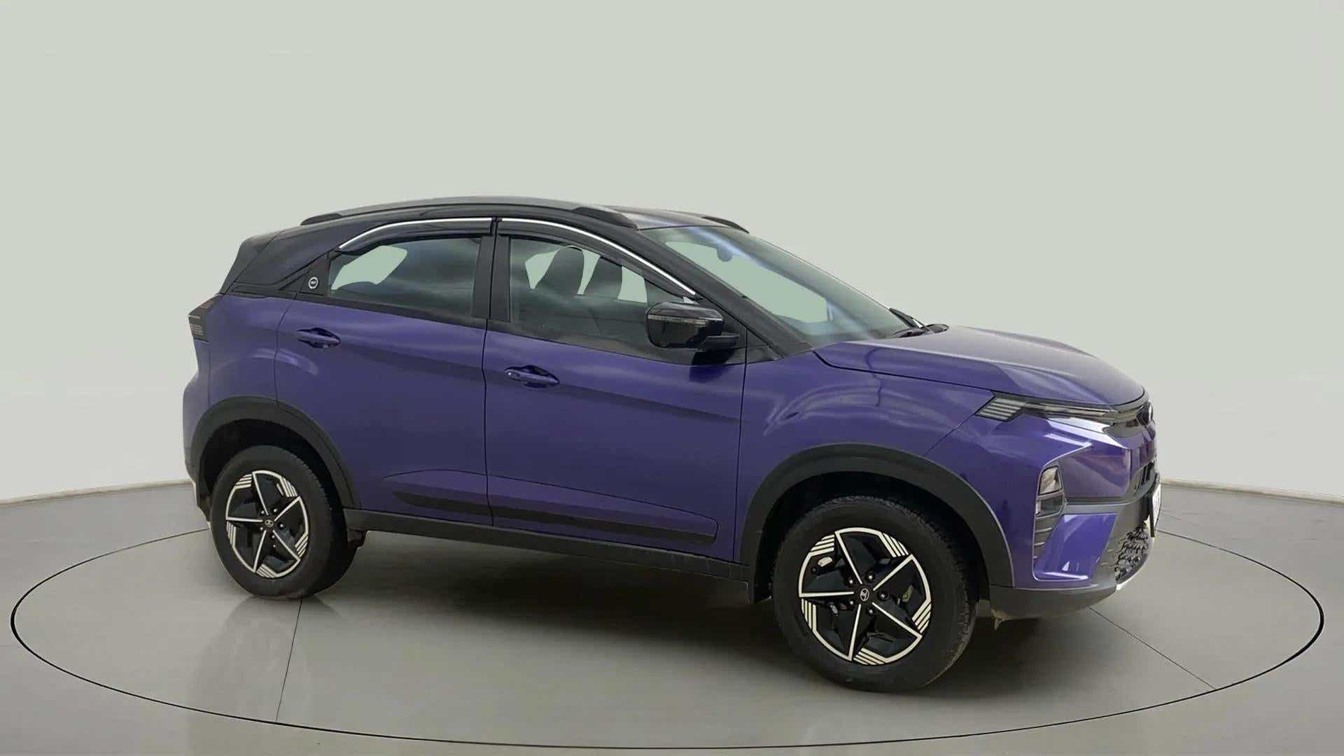 Side view of a royal blue Tata Nexon