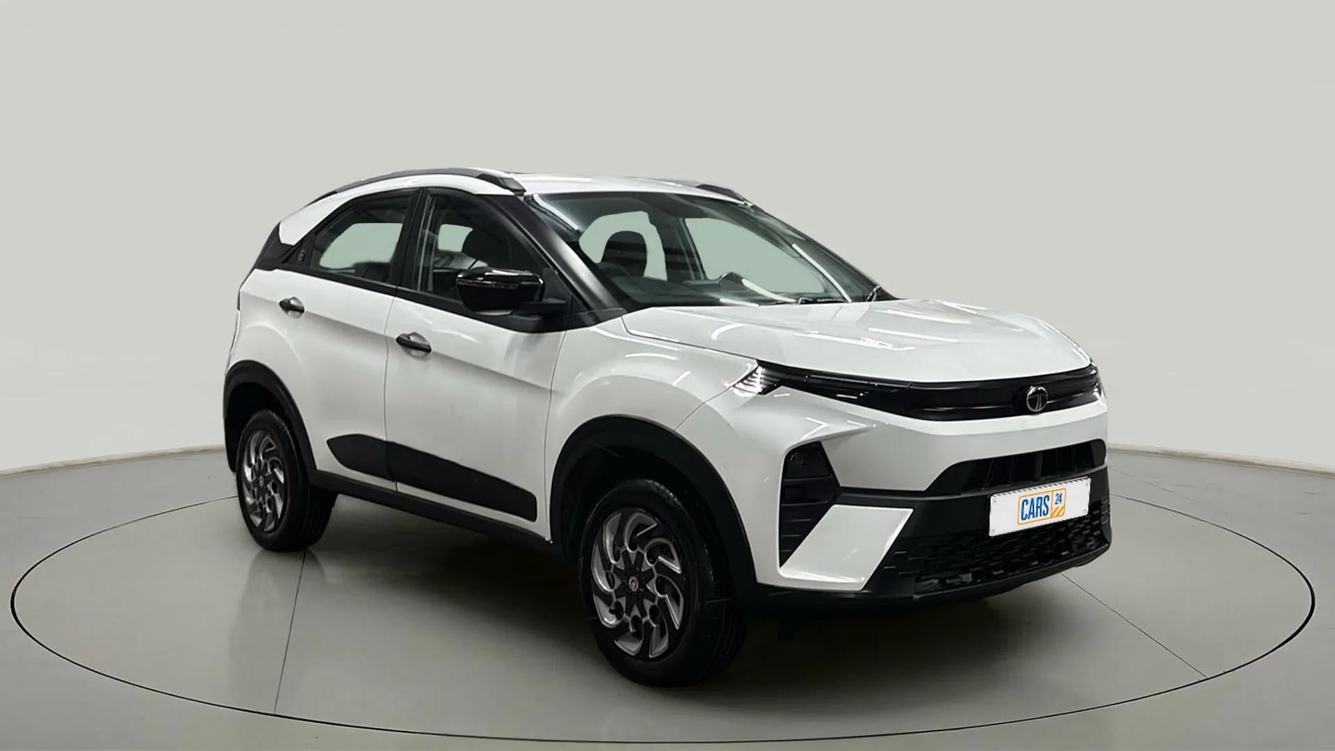 Front three-quarter view of a Calgary White Tata Nexon