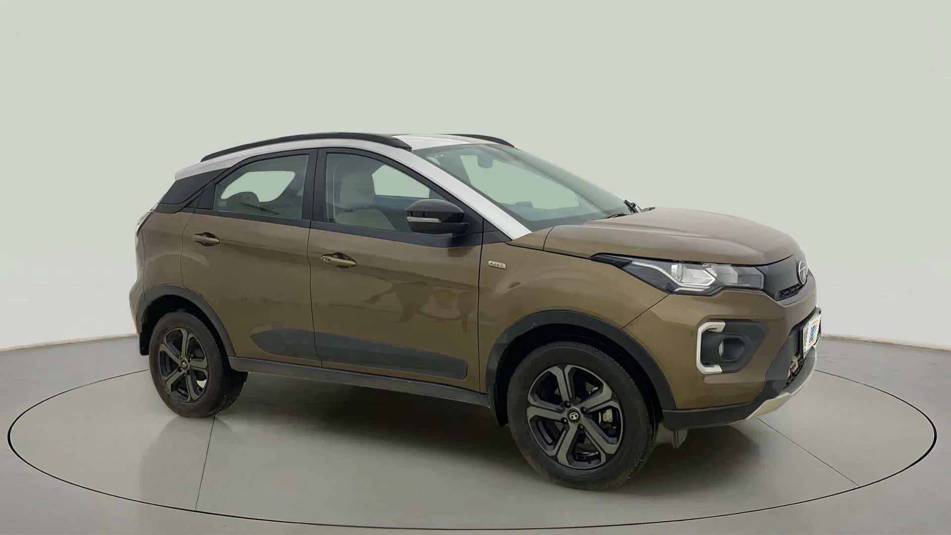 Front side view of a Grassland Beige Tata Nexon 2017-2023