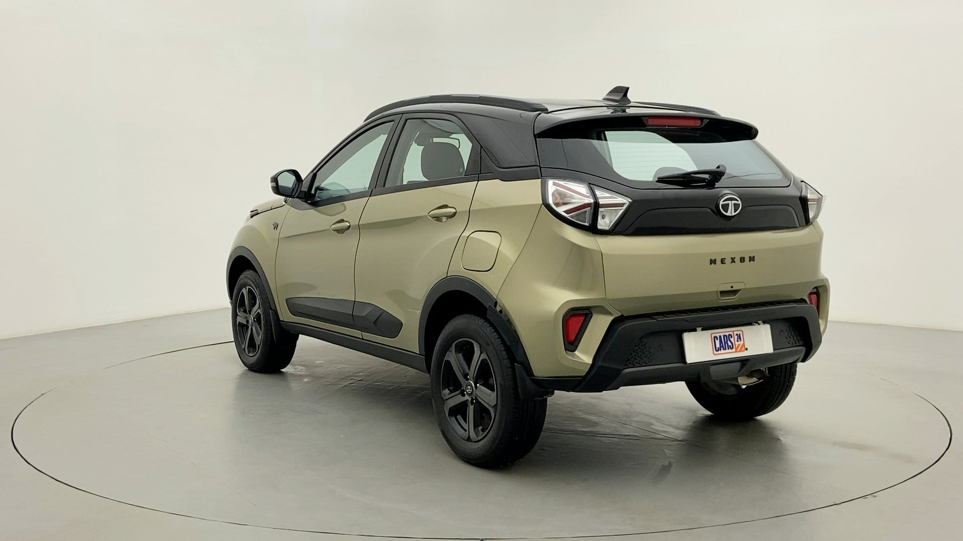 Rear three-quarter view of a Grassland Beige Tata Nexon 2017-2023