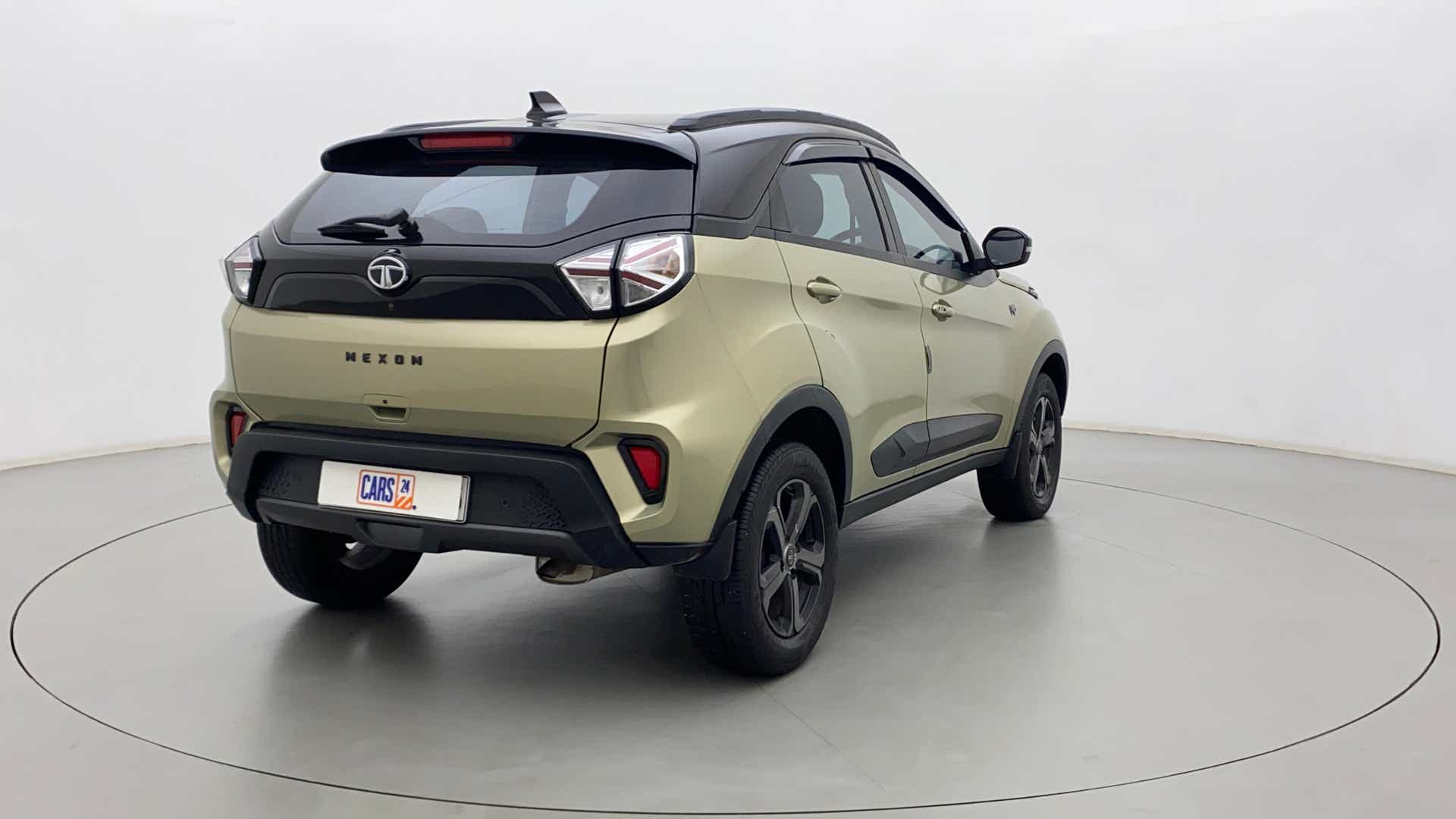Rear three-quarter view of a Grassland Beige Tata Nexon 2017-2023