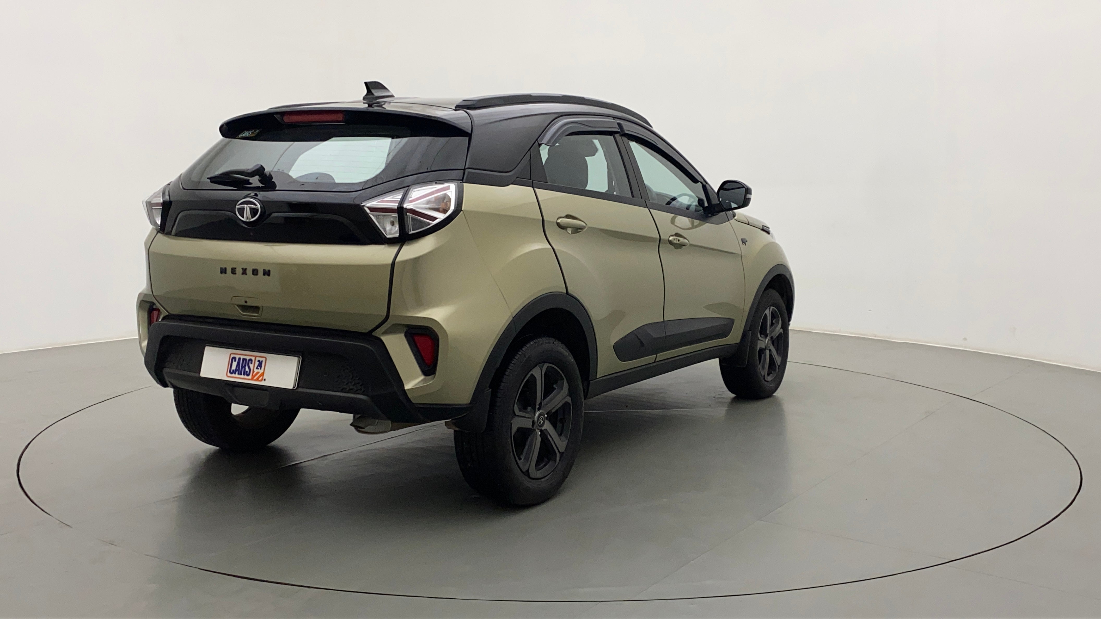 Rear three-quarter of a Grassland Beige Tata Nexon 2017-2023