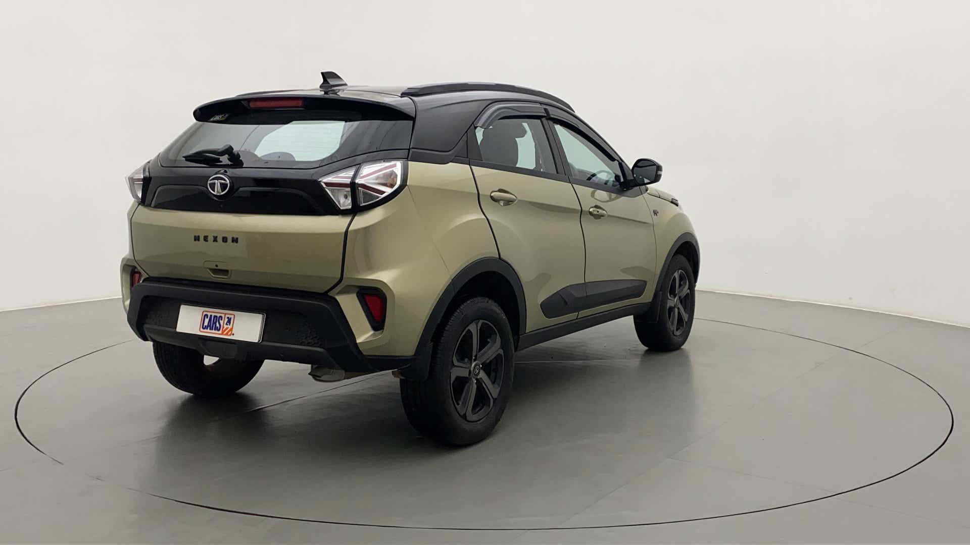 Rear three-quarter of a Grassland Beige Tata Nexon 2017-2023
