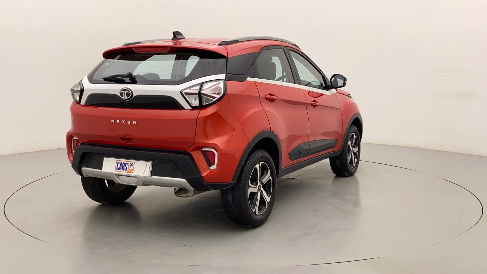 Rear three-quarter of a flame red Tata Nexon 2017-2023
