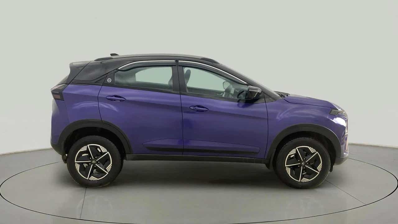 Side view of a royal blue Tata Nexon