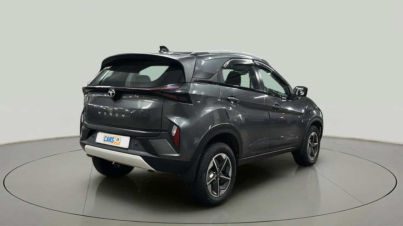 Rear three-quarter view of a daytona grey Tata Nexon
