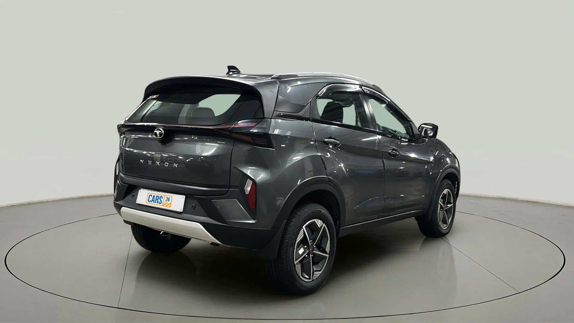 Rear three-quarter view of a daytona grey Tata Nexon