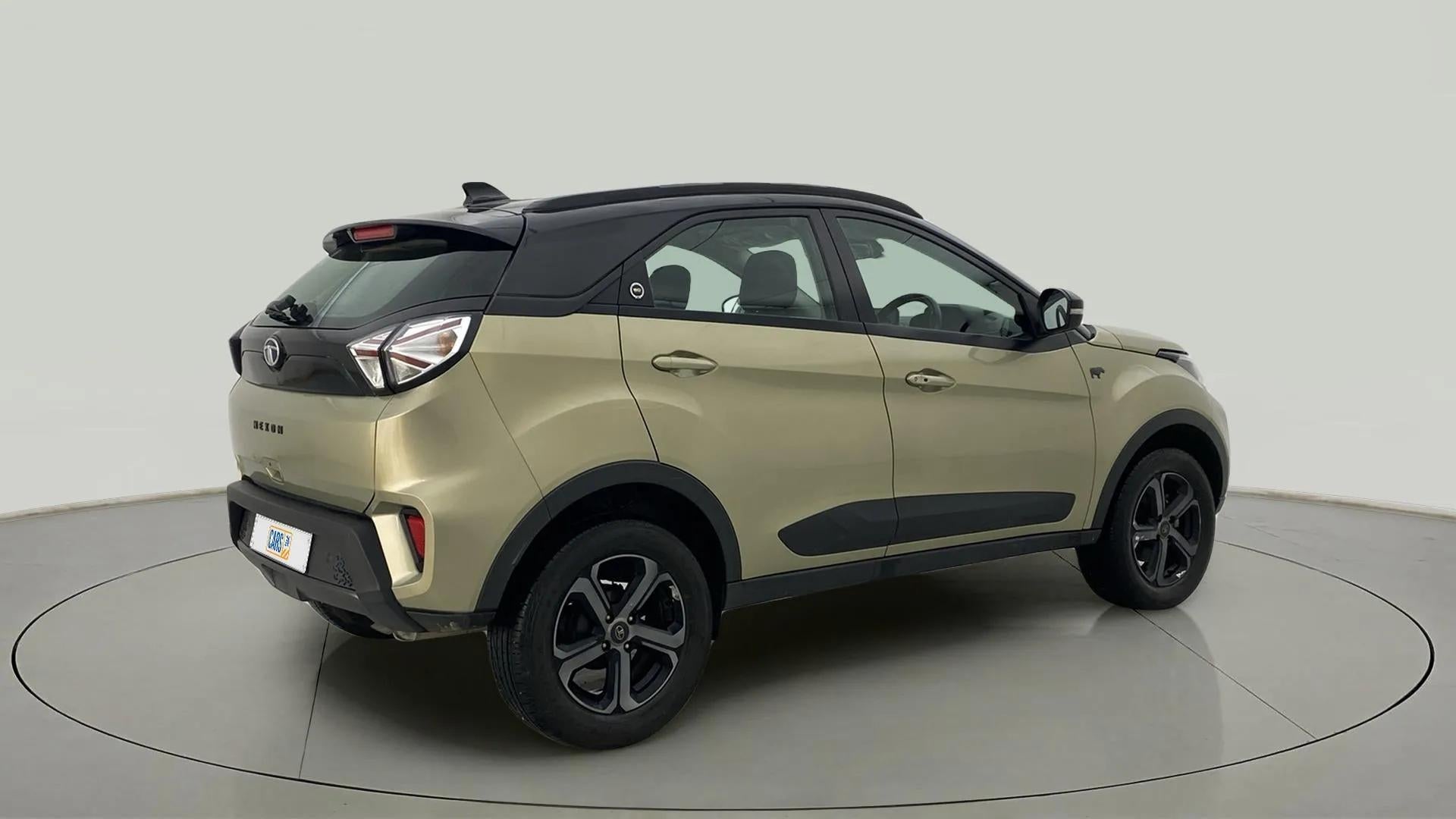 Rear three-quarter view of a Grassland Beige Tata Nexon 2017-2023