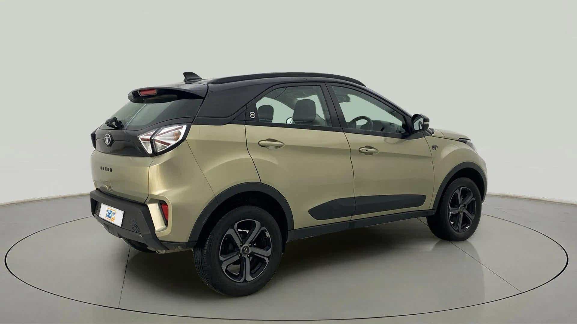 Rear three-quarter view of a Grassland Beige Tata Nexon 2017-2023