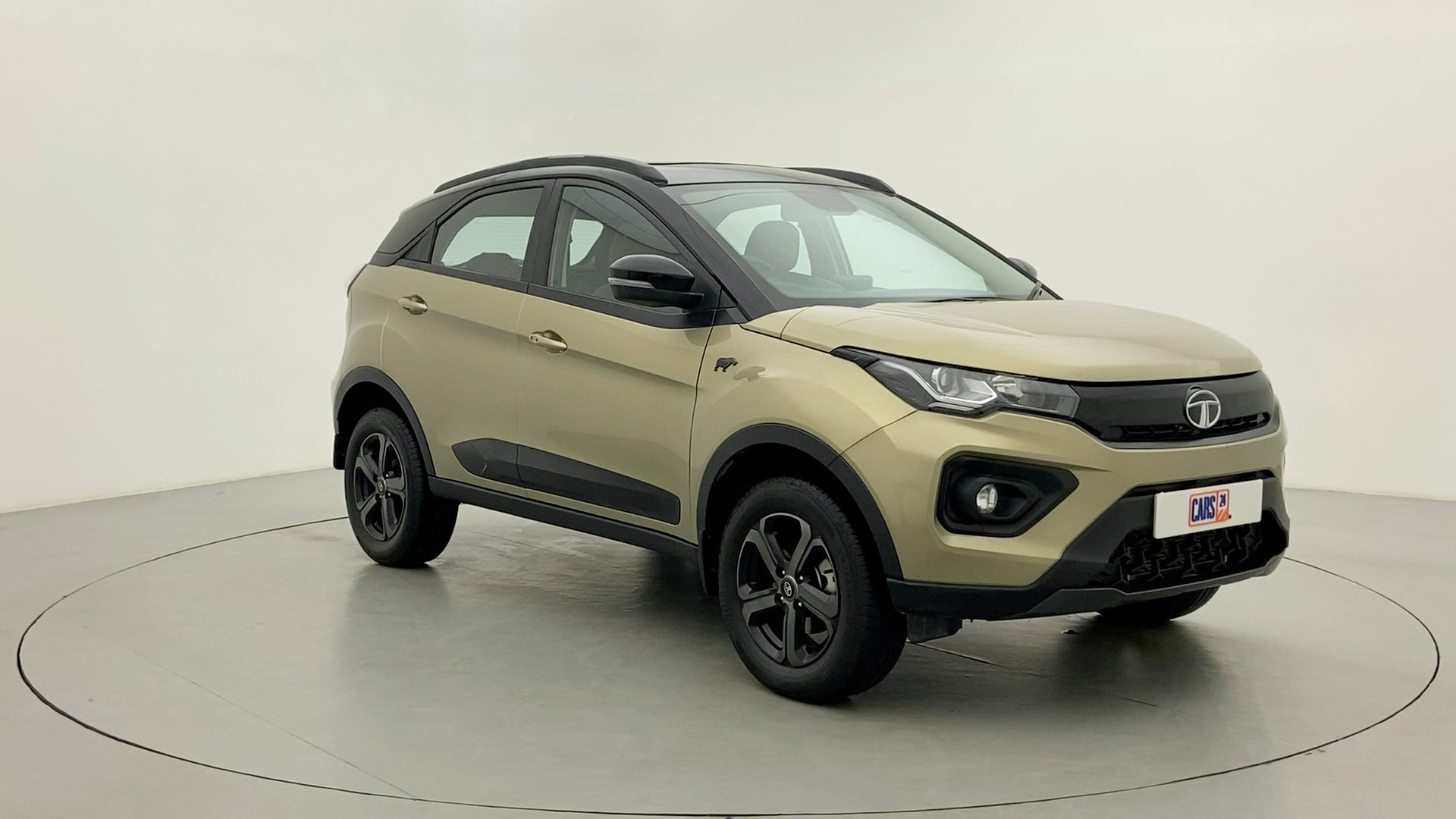 Front three-quarter view of a Grassland Beige Tata Nexon 2017-2023