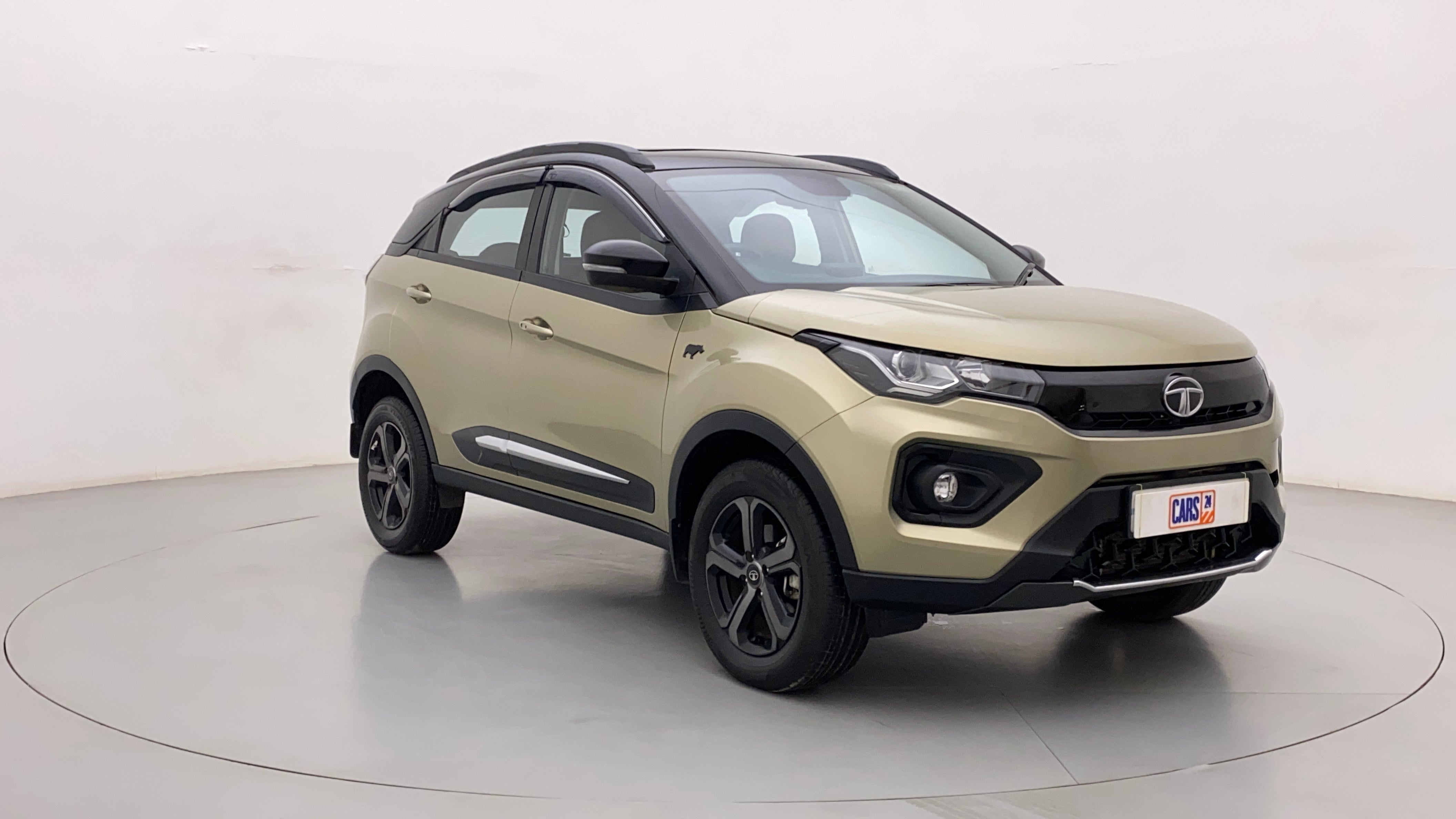 Front three-quarter view of a Grassland Beige Tata Nexon 2017-2023
