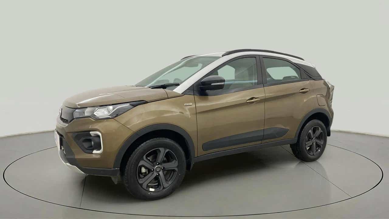 Front side view of a Grassland Beige Tata Nexon 2017-2023