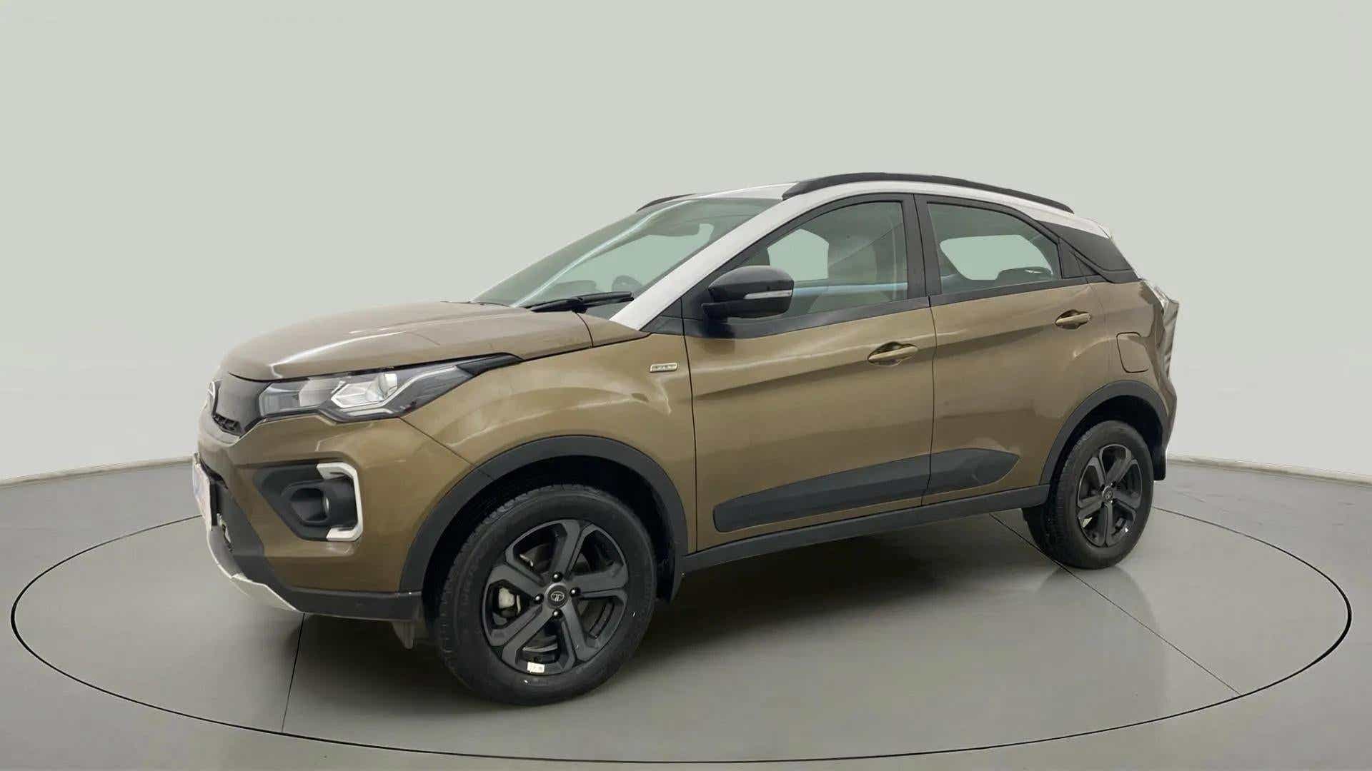 Front side view of a Grassland Beige Tata Nexon 2017-2023